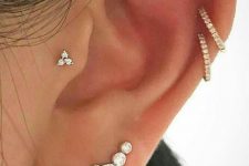 a cool ear stack with a faux rook, double helix, lobe and tragus piercing done with lovely studs and hoops
