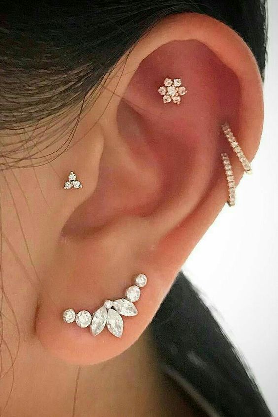 a cool ear stack with a faux rook, double helix, lobe and tragus piercing done with lovely studs and hoops