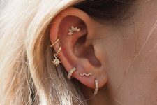 a cool ear stack with triple lobe, double helix and a faux rook piecring all done with chic hoops and studs