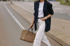 a cool summer work look with a white t-shirt, white jeans, an oversized black blazer and a black belt, white birkenstocks and a woven bag