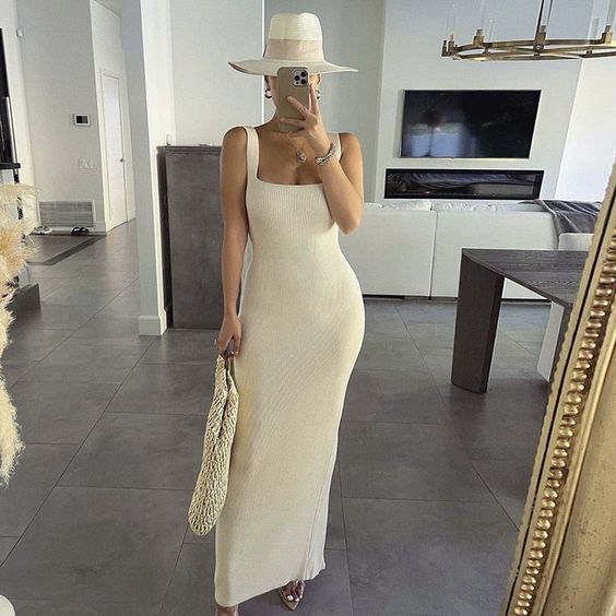 a creamy ribbed maxi tank dress with a square neckline, nude shoes, a creamy hat and a woven bag for an elegant coastal look