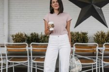 a delicate summer work outfit with white wideleg jeans, a blush t-shirt, blush slides and a woven white bag is lovely
