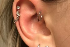 a double forward helix, double helix and lobe piercing done with hoops and studs plus chain is a cool idea