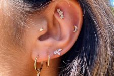 a lovely ear stack with a triple lobe, tragus, helix and faux rook piercing all done with chic studs and hoops with pendants