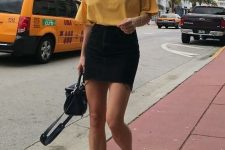 a lovely and easy summer look with a yellow t-shirt, a black denim mini, white sneakers and a black bag is easy to repeat