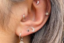 a lovely boho ear look with a faux rook, helix, triple lobe and a tragus piercing done with white gold studs and hoops