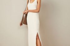 a minimalist summer outfit with a creamy tank midi dress with a slit on buttons, black sandals and a brown tote