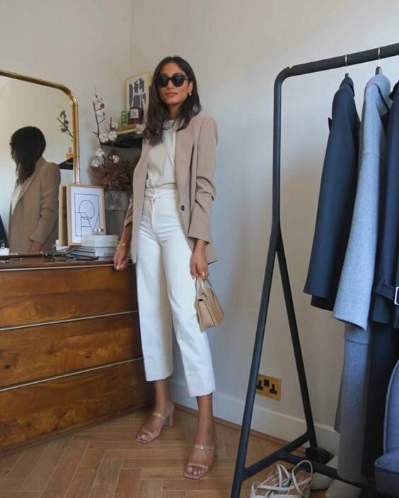 a neutral top, white cropped jeans, nude heels, a beige blazer and a small tan bag for an office look