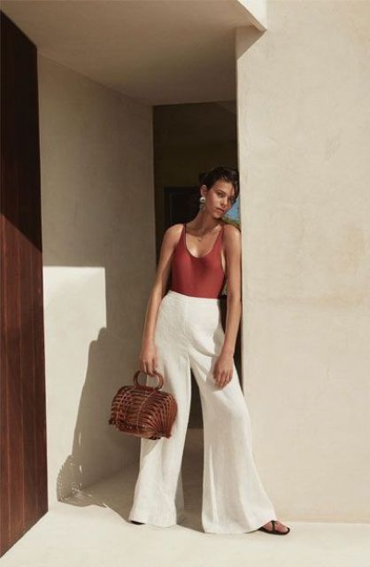 a refined and minimalist summer look with a burgundy bodysuit, white wideleg pants, black sandals and a wooden bag