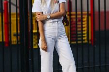 a simple and cool look with a white t-shirt, white jeans, a nude bag and pink velvet kitten heels for a touch of color