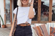 a simple and lovely outfit with a white crop top, a black denim mini, a brown belt and a bag plus chic statement jewelry