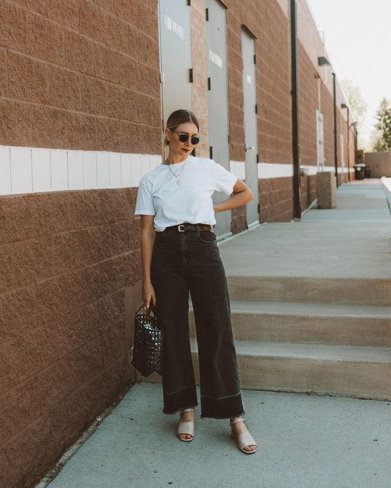 a simple summer look with a white t shirt, black wide leg pants, neutral shoes and a black woven bag