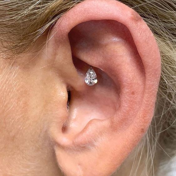 a single hidden rook piercing done with a large crystal drop is a beautiful and very unusual idea to try