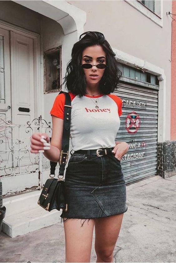 a summer look with a printed 90s tee, a black denim mini, a black bag and layered necklaces plus small sunglasses