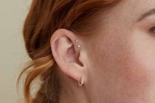 a super delicate ear with a double forward helix piercing and a single lobe one done with a hoop
