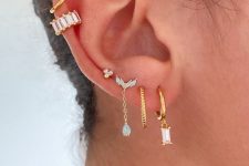 a super glam ear stack with multiple lobe, helix and faux rook piercings done with lovely gold hoops and studs