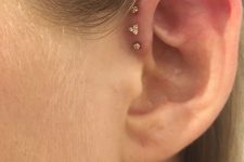a triple forward helix piercing done with matching gold studs is a lovely idea for a modern look, no other piercings required