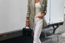a white top, white cuffed jeans, black heeled shoes, an olive green blazer and a small black bag for summer