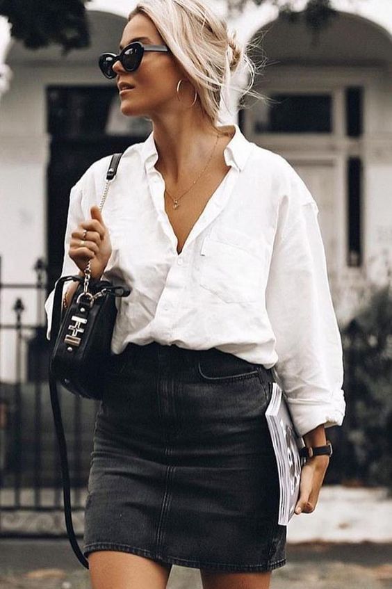 an oversized white shirt, a black denim mini, a black bag and gold jewelry are a chic and cool combo for summer