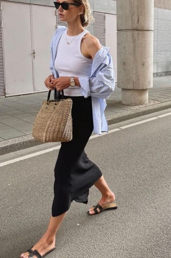 a white halter neckline top, a blue oversized shirt, a black pencil midi skirt, black flipflops and a straw bag for a more relaxed office look