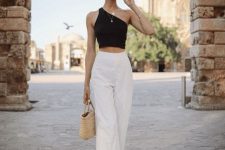 04 a black one shoulder crop top, white high waisted pants, black strappy heels and a woven bag for an elegant minimal look