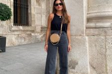 07 a minimalist every day look with a black halter neckline top, black flare high waisted jeans, black slippers and a round bag in beige