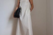 11 a minimalsit look with a white A-line midi dress with a halter neck, black sandals and a black bag plus layered necklaces