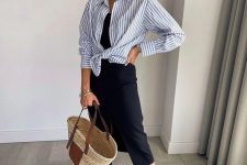 12 a summer work look with a hint of vacations, with a black slip midi dress, a black and white striped shirt, brown sliders and a straw bag