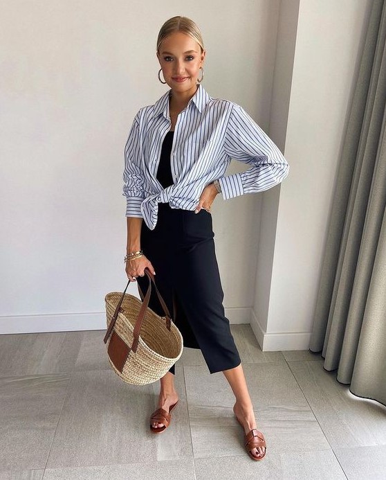 a summer work look with a hint of vacations, with a black slip midi dress, a black and white striped shirt, brown sliders and a straw bag