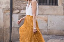 14 a romantic look with a white cami top, a yellow printed pleated midi, neutral lace up shoes, a pearl necklace and a straw hat