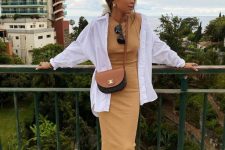 14 a vacation outfit with a yellow maxi dress, an oversized white shirt, a two-tone bag and brown slides