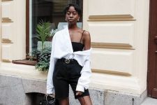 17 a black and white look with a spaghetti strap top, black biker shorts, black shoes, an oversized white shirt and a black bag