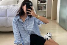 18 a blue thin stripe oversized shirt, black biker shorts, black and white trainers and white socks for every day