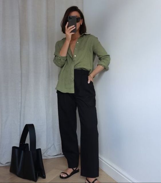a green linen shirt, black linen pants, black strappy sandals and a black tote for work in summer