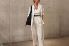 23 a minimalist all-neutral outfit with a top, an oversized shirt, high waisted pants, black flipflops and a black bag