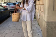 24 a neutral summer outfit with an oversized white shirt, neutral jeans, flipflops and a woven bag