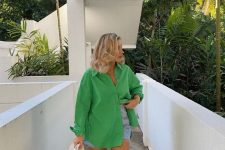 26 an apple green oversized shirt, blue denim shorts, neon green sandals and a white clutch are a lovely look for a hot day