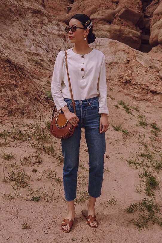 a white button blouse, blue crop straight jeans, a brown bag and brown slides plus hair pins for an accent