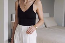 34 an elegant outfit with a black bodysuit, white high waisted pleated pants and a chic necklace is work-appropriate