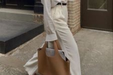 36 an oversized white shirt, creamy high waisted pants, black shoes, a beige tote and a black belt