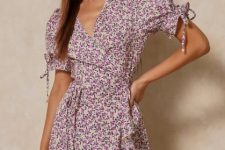 A lilac and white floral printed short sleeved wrap mini dress with ruffles
