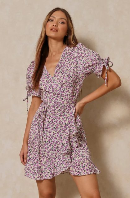 A lilac and white floral printed short sleeved wrap mini dress with ruffles