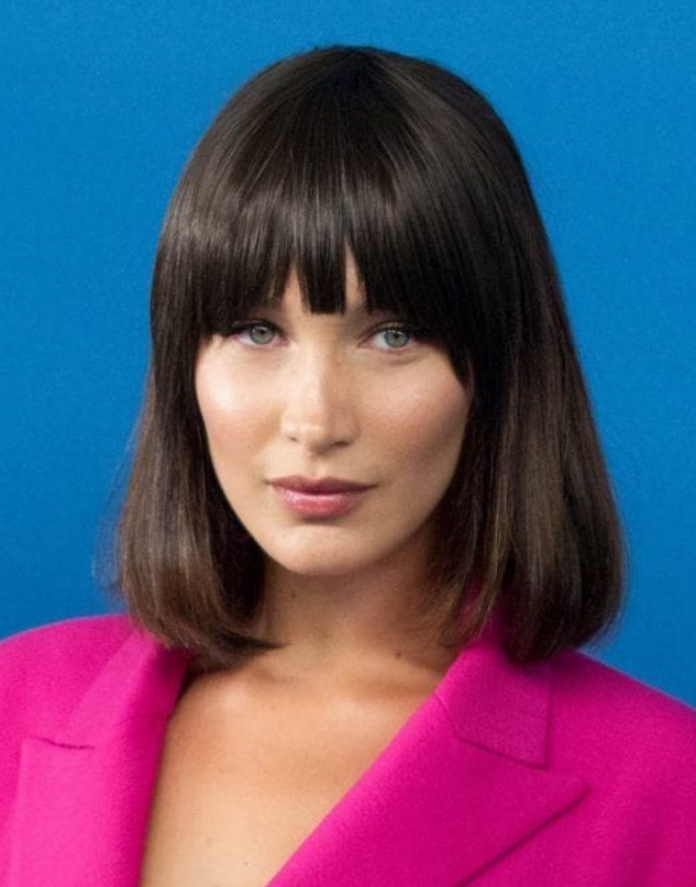 Bella Hadid wearing a dark brown liqud bob with bangs inspired by an iconic hairstyle of Michelle Pfeiffer