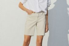 With beige straw hat, white loose button down shirt and beige lace up flat sandals