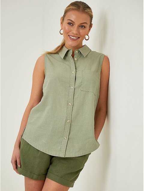 With golden rounded earrings and olive green cuffed shorts