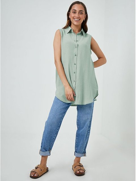 With light blue cuffed loose jeans and brown embellished flat sandals