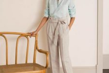 With light blue linen button down shirt and brown leather flat sandals