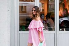 With oversized sunglasses, clutch and pale pink ankle strap heeled shoes