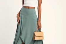 With white halter crop top, beige leather mini bag and beige lace up high heels
