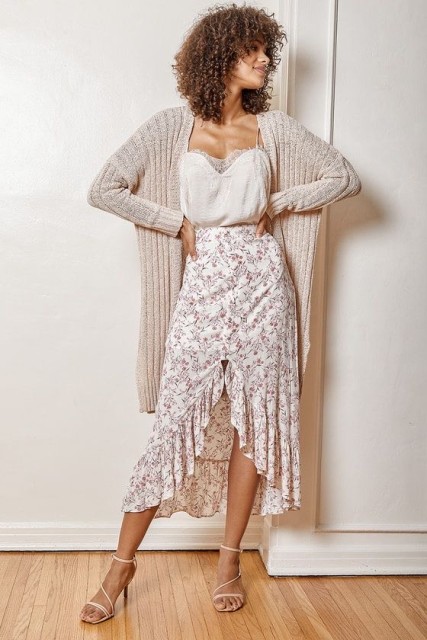With white lace and satin sleeveless top, beige long cardigan and white lace up high heels